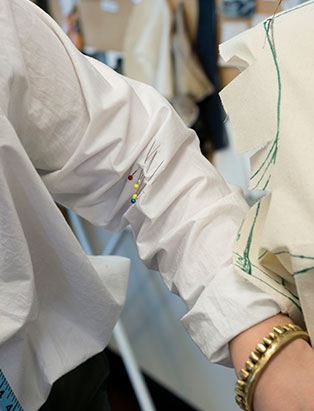 top fashion design school graduate instructor sara armstrong pins white shirt