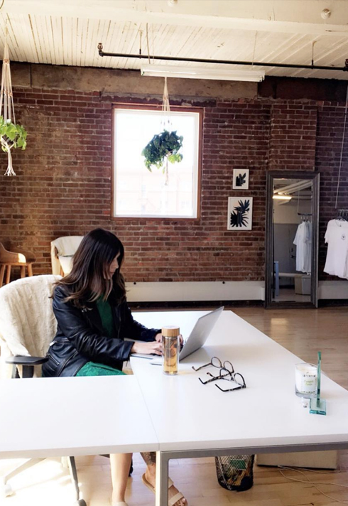 tara osipoff working at her desk at ayden creative