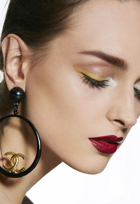 Freelance makeup artist, Ana V De G's makeup look with bold red lips, and a pair of Chanel earrings.