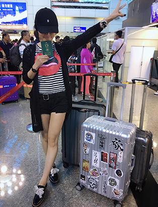 sunny lee at airport with luggage mua graduate bmc