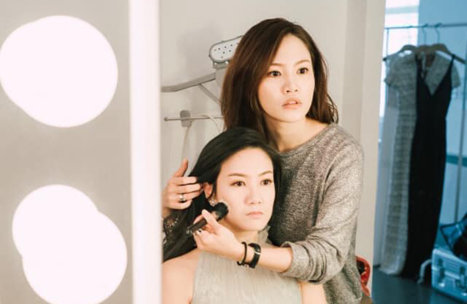 international makeup graduate sunny lee working with a bridal makeup client