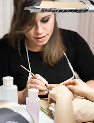 nail studio program student practicing gel nail soak off technique