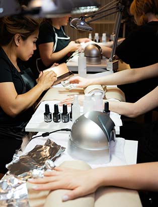 nail art and design students practicing nail art at blanche macdonald's uptown campus