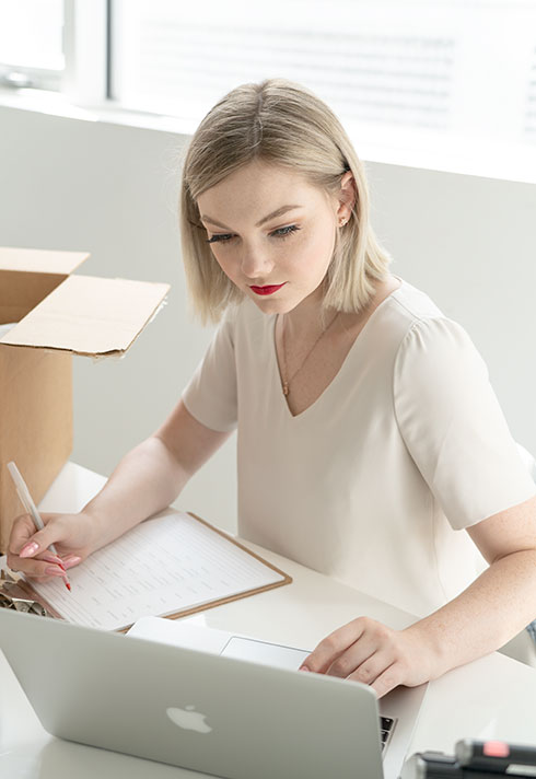 Emily Buhr in room checking boxes of inventory