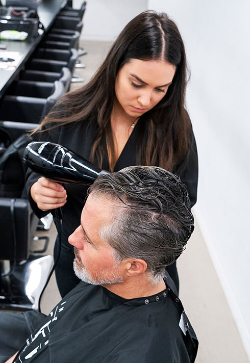 BMC instructor Sandra Perovic blowdrying mens hairstyle