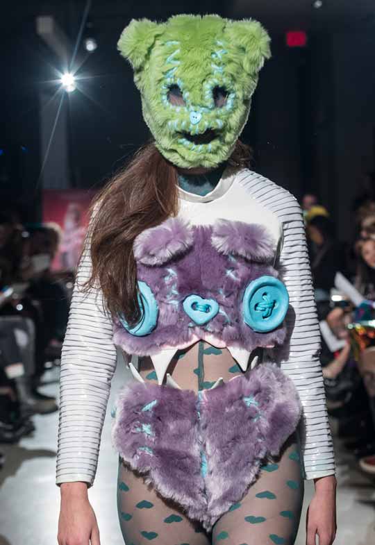 model wearing green bear mask and purple faux fur by Peter Zuk at BMC grad show