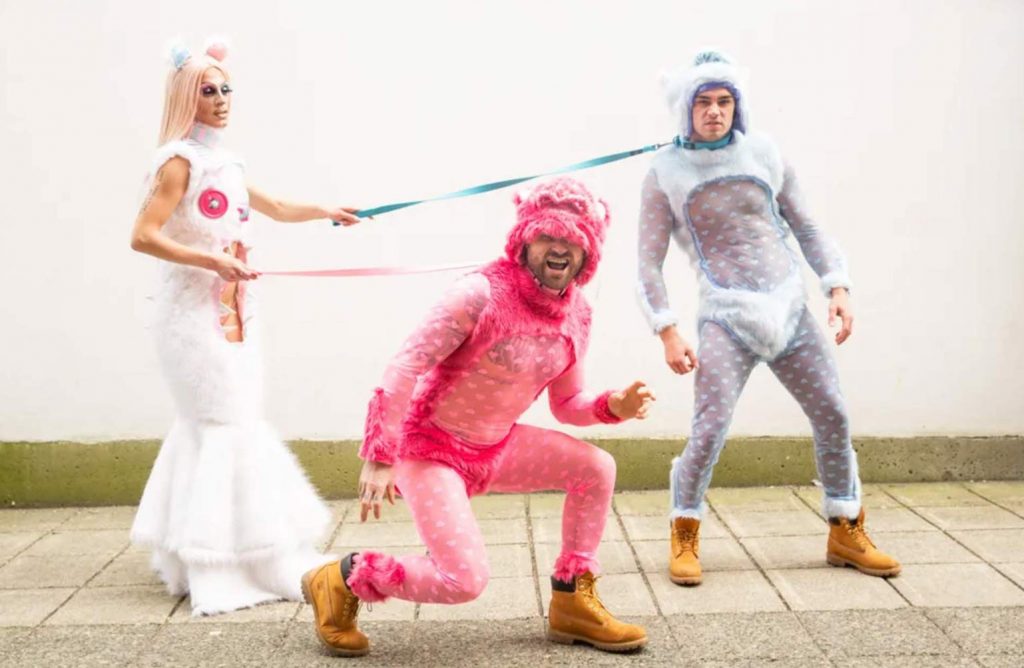 drag queen walking two bears wearing Peter Zuk clothing in Paper Magazine