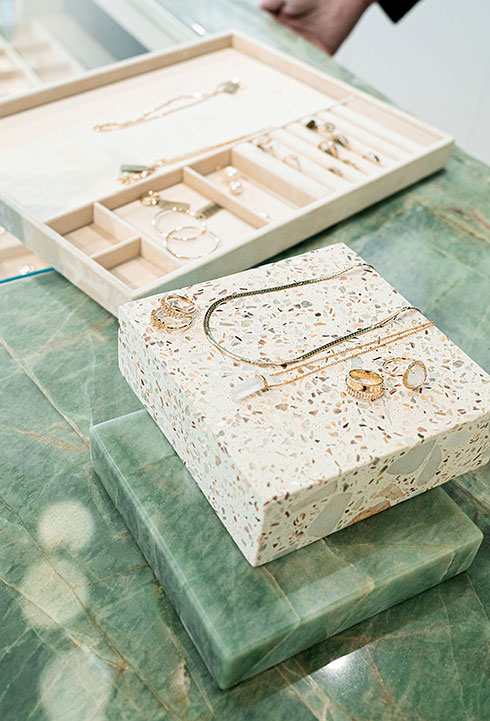 jewelry display on green marble and terrazzo