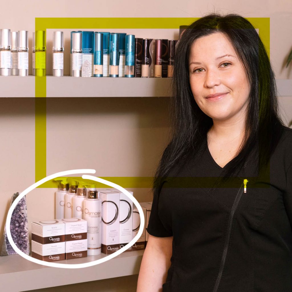 BMC esthetics graduate Christina Makrodimitras standing in front of products