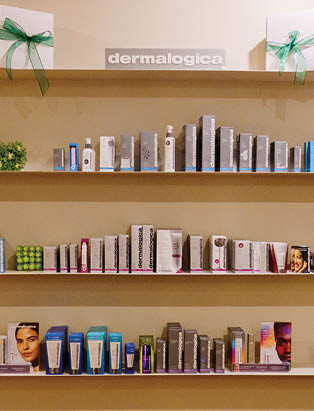 Three wall mounted shelves full of Dermalogica product