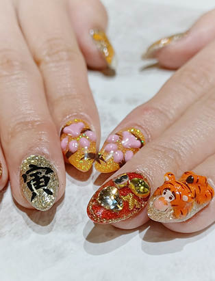 Glittery year of the tiger themed nails, Tigger