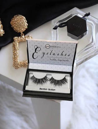 a set of full, Haus of V lashes displayed on counter in box