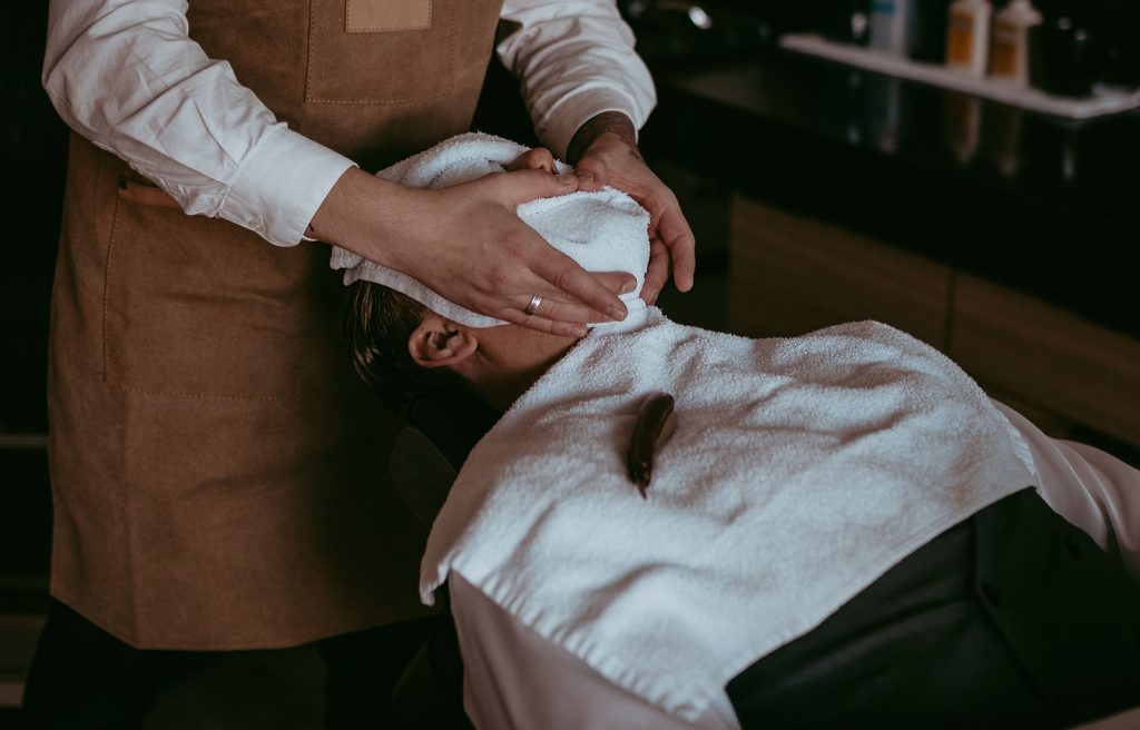 Close up shot of hot towel service on a client provided at Black Forest Barbershop