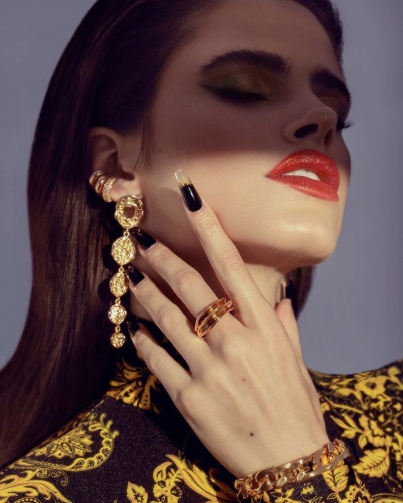 closeup shot of model with red lipstick in Versace top, artist Melfinna Tjugito