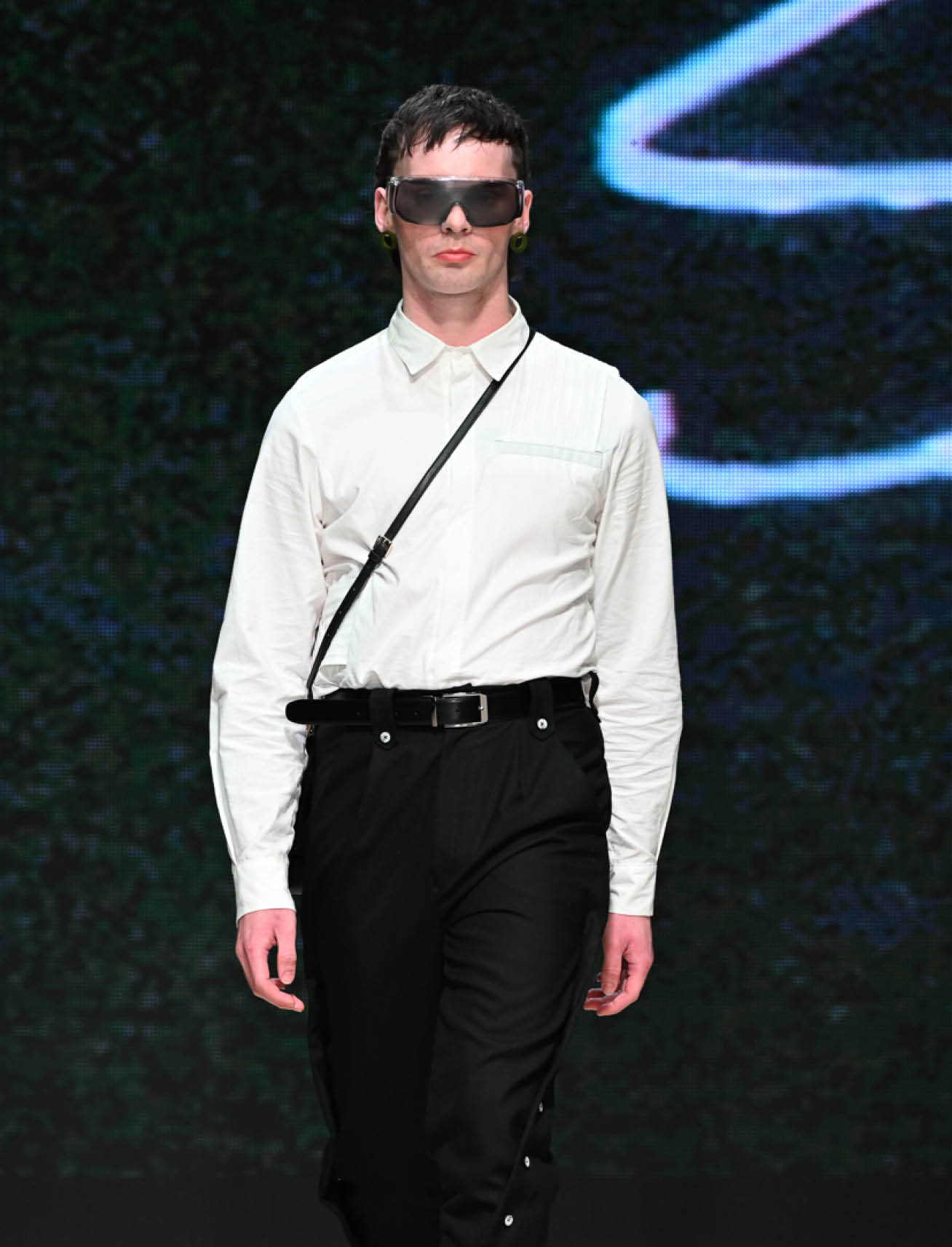 model wearing unisex garments, white button up and black pants from label Shivajothi