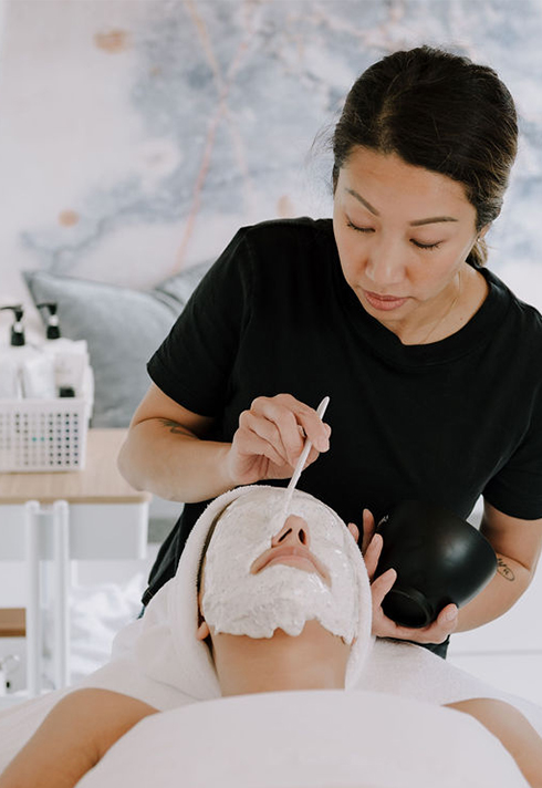 Blanche Macdonald Graduate Gwen de la Costa performing a facial