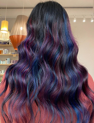 the back of a women's head with purple and blue highlights in a long length spiral waves hairstyles, styled by Kevin Murphy Colour Educator Kalli Wyssen