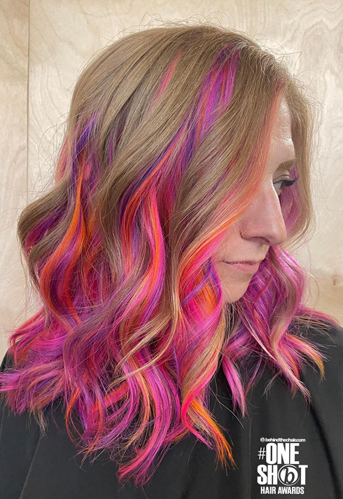 a woman with pink and light taupe hair color, wearing full curls, defined waves mid length hairstyles, styled by Kevin Murphy Colour Educator Kalli Wyssen