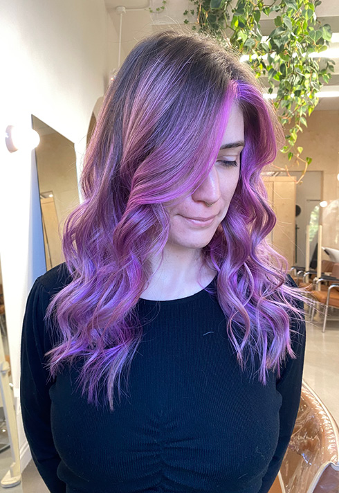 a woman with light mauve long length hairstyles, wearing a full curls, at Stone Fox Salon, coloured by Kevin Murphy Colour Educator Kalli Wyssen