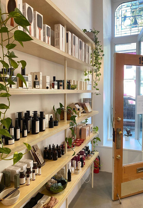 inside of Stone Fox Hair Salon with shelves filled with hair products and plants.