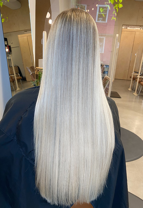 the back of a woman's head with straight, blonde, extra long length hairstyles, coloured by Kevin Murphy Colour Educator Kalli Wyssen