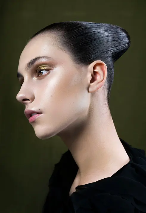 Close up of Genevieve Oxtoby, with green eyeshadow,and stood up hairstyle created by runway stylist Sam Groeneveld