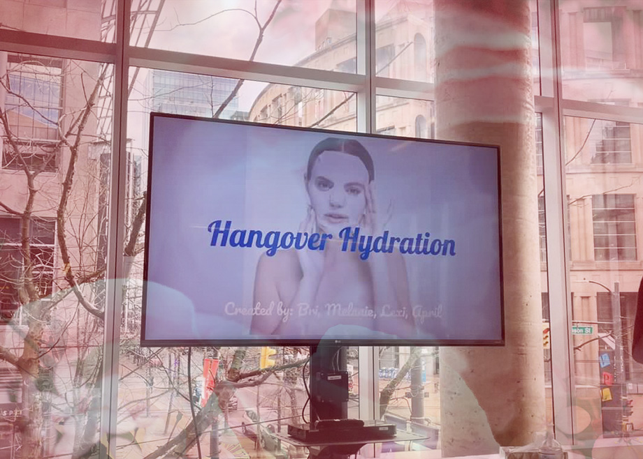 Blanche esthetics students presenting Hangover Hydration during Dragon's Den presentation on a TV screen.