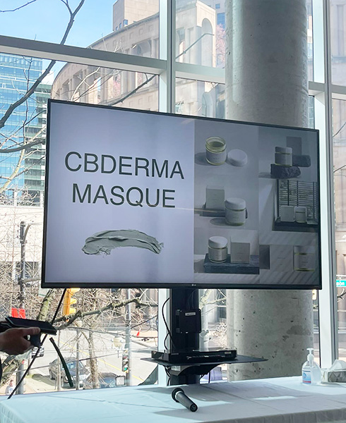 Blanche esthetics students presenting CBDERMA Masque during Dragon's Den presentation on a TV screen.