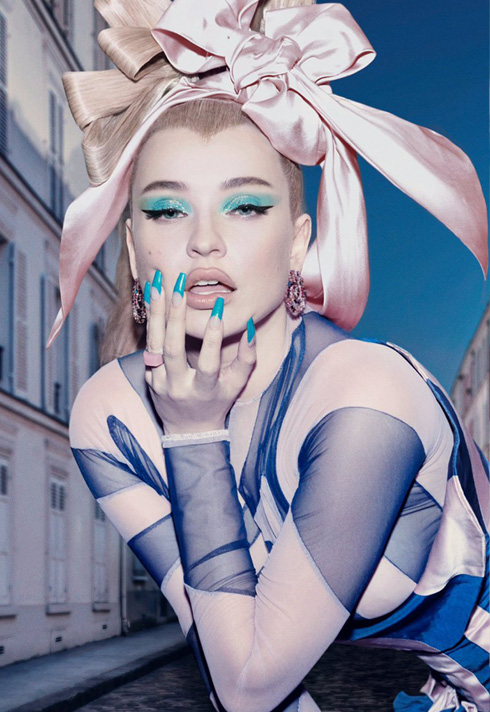 Kim Petras wearing a pink bow on her head, with blue makeup by Jenna Kuchera, First Assistant for Pat McGrath.  