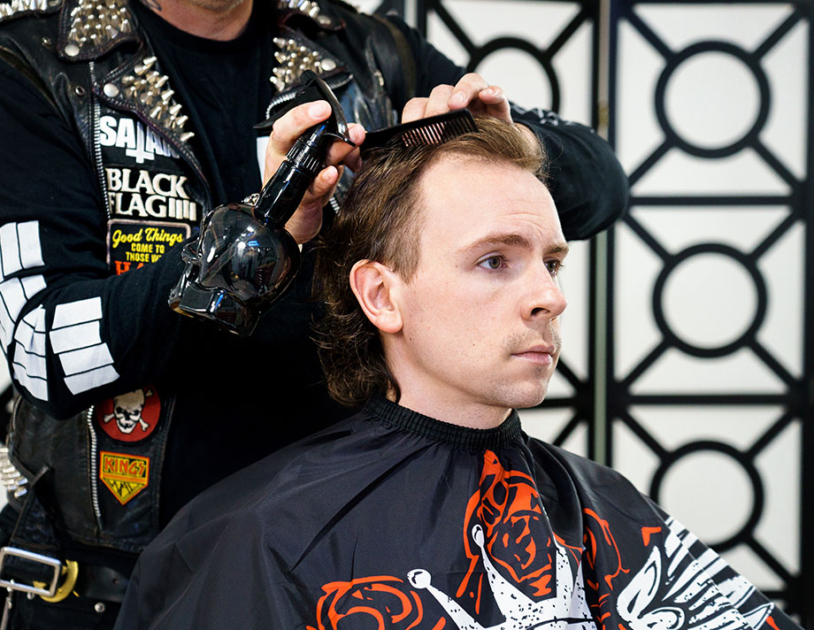 still of Ash, holding a hair clipper in his barbershop