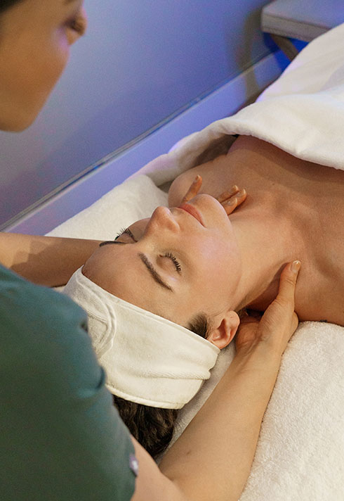 A lady is receiving neck massages by Laser esthetics technician Jackie.