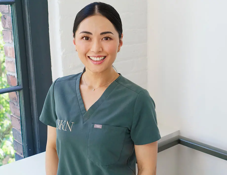 Profile picture of Laser esthetics technician Jackie standing behind a white background.