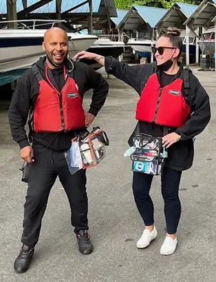 Kara Alaric with Blanche grad, Micah Gilbert with red lifejackets
