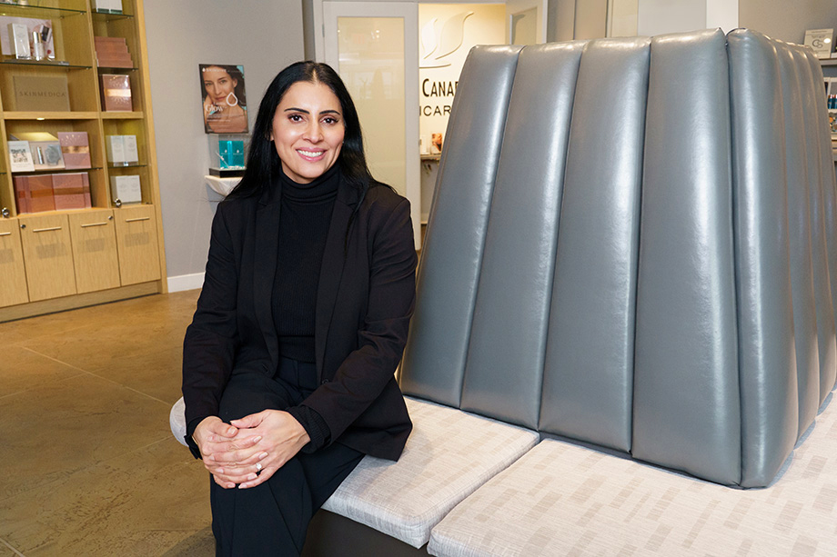 Jas sitting at the reception area smiling at the camera