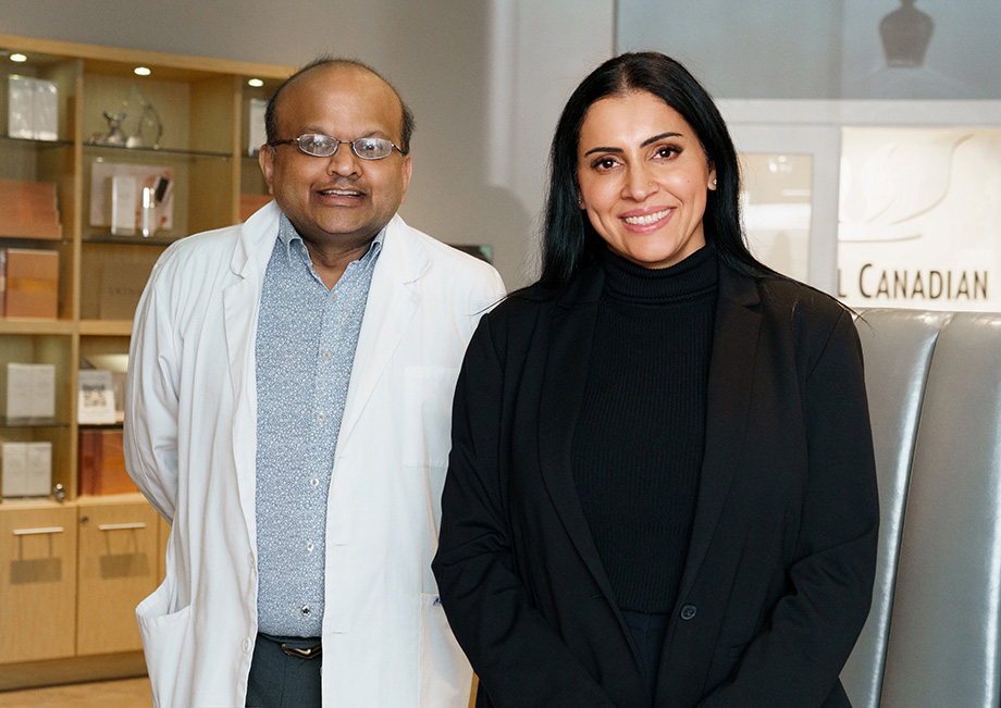 Jas Sahota wearing black standing besides Dr Shah, wearing a lab coat