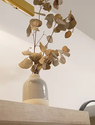 An aesthetic grey vase with dry leaves