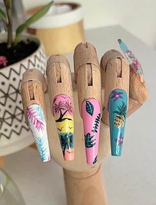 A wooden hand manique with summery nail design in a long coffin shape 