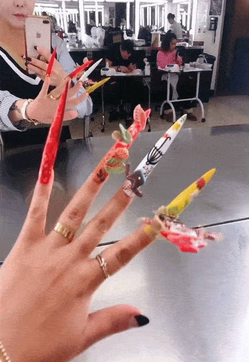3D acrylic nail set created by Hailey Lee, in a long stiletto shape with 3D attachments.
