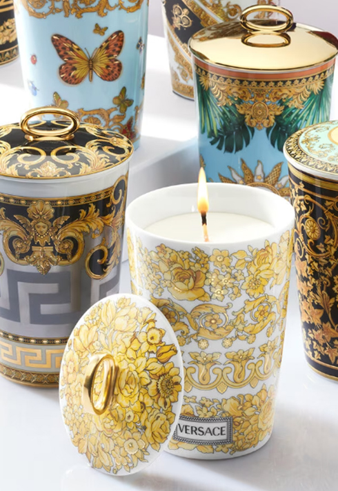 Product shot of Versace Home's i ♡ baroque scented candle a white print with a golden Medusa in the center